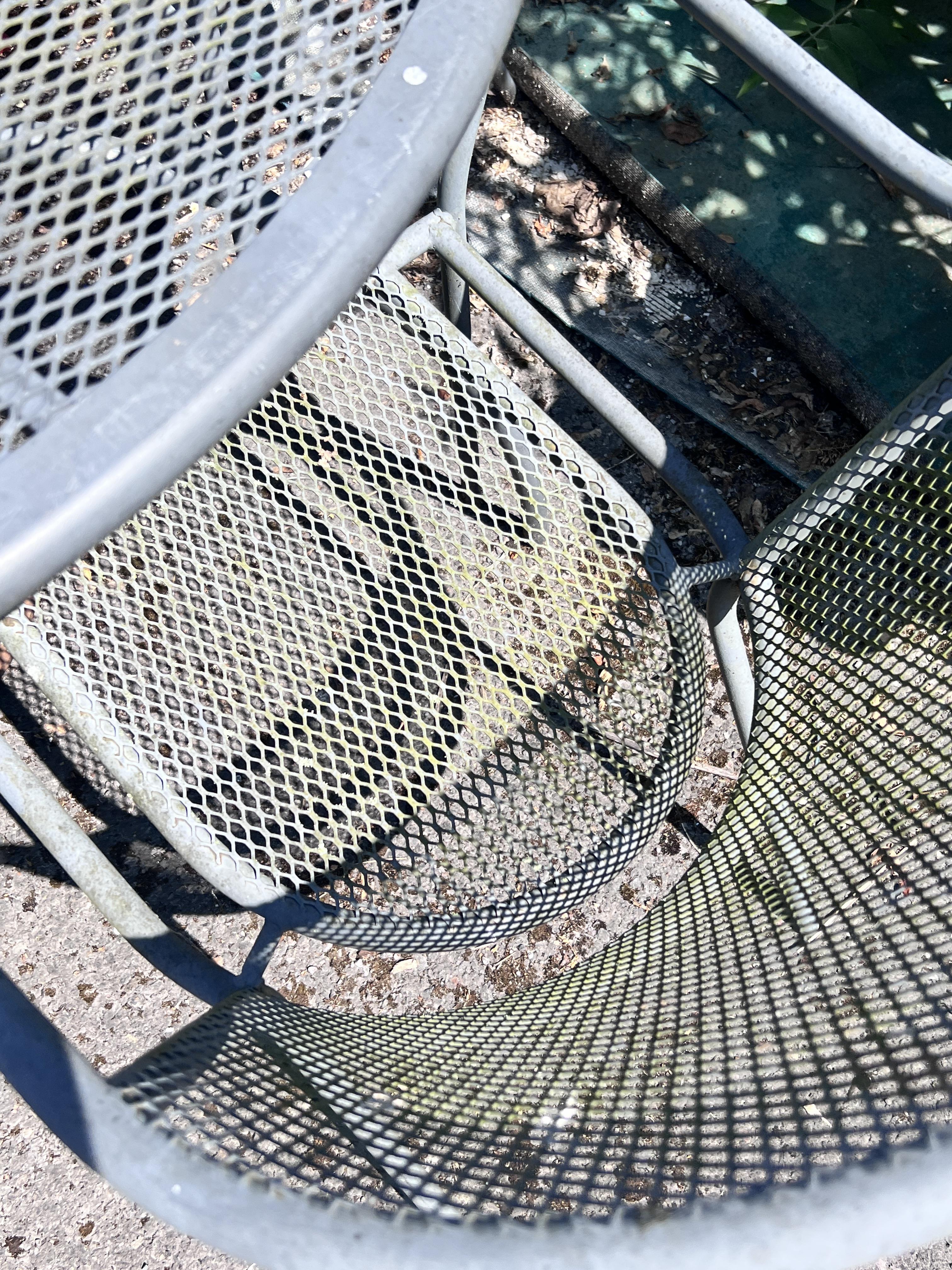 A Kettler circular metal garden table, diameter 110cm, height 72cm, and four chairs